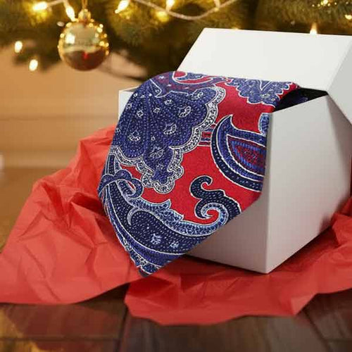 Paisley necktie under a Christmas tree in a gift box