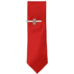 A solid red tie with a silver tie bar featuring Santa in a chimney