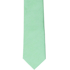 The front of a seafoam slim tie, laid out flat