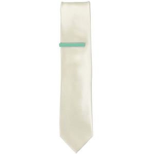 A solid seafoam tie bar on an ivory slim tie  Edit alt text