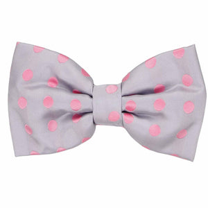 A silver men's pre-tied bow tie with light pink polka dots all over