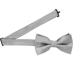 A pre-tied silver bow tie with the band collar open
