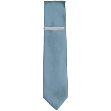 Load image into Gallery viewer, A silver tone skinny tie bar on a serene blue slim tie