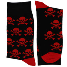 Load image into Gallery viewer, Folded men’s black crew socks with red skull and crossbones pattern, skull novelty socks for men