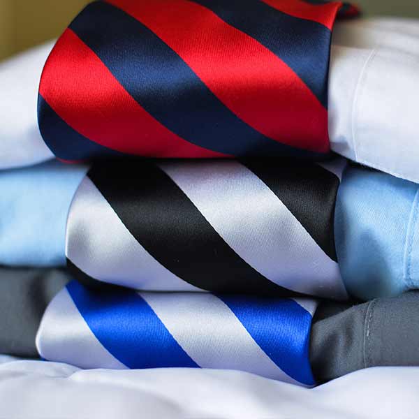 Striped neckties stacked with dress shirts