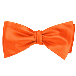 A tangerine self-tie bow tie, tied