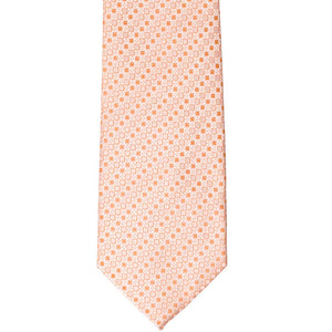 The front of a bright orange tie with a small square pattern