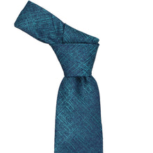 Load image into Gallery viewer, A teal blue necktie with a subtle diagonal textured pattern, tied in a standard knot and displayed against a solid white background.
