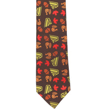 Load image into Gallery viewer, The front of a front Thanksgiving slim necktie, with turkeys, leaves, acorns and pie