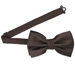 A truffle brown pre-tied bow tie with the band collar open