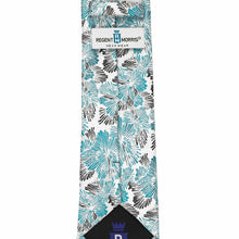 Load image into Gallery viewer, A necktie with a white base featuring a turquoise and black floral pattern, folded with its Regent Morris Neckwear tag visible at the top.