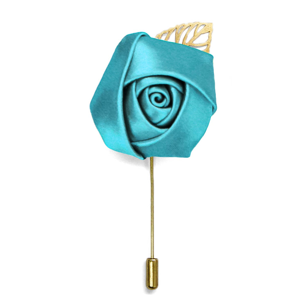 A turquoise flower lapel pin with a gold pin and leaf