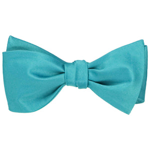 Solid color turquoise self-tie bow tie, tied