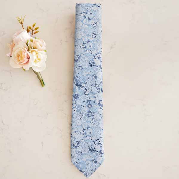Dusty blue wedding tie with a boutonniere