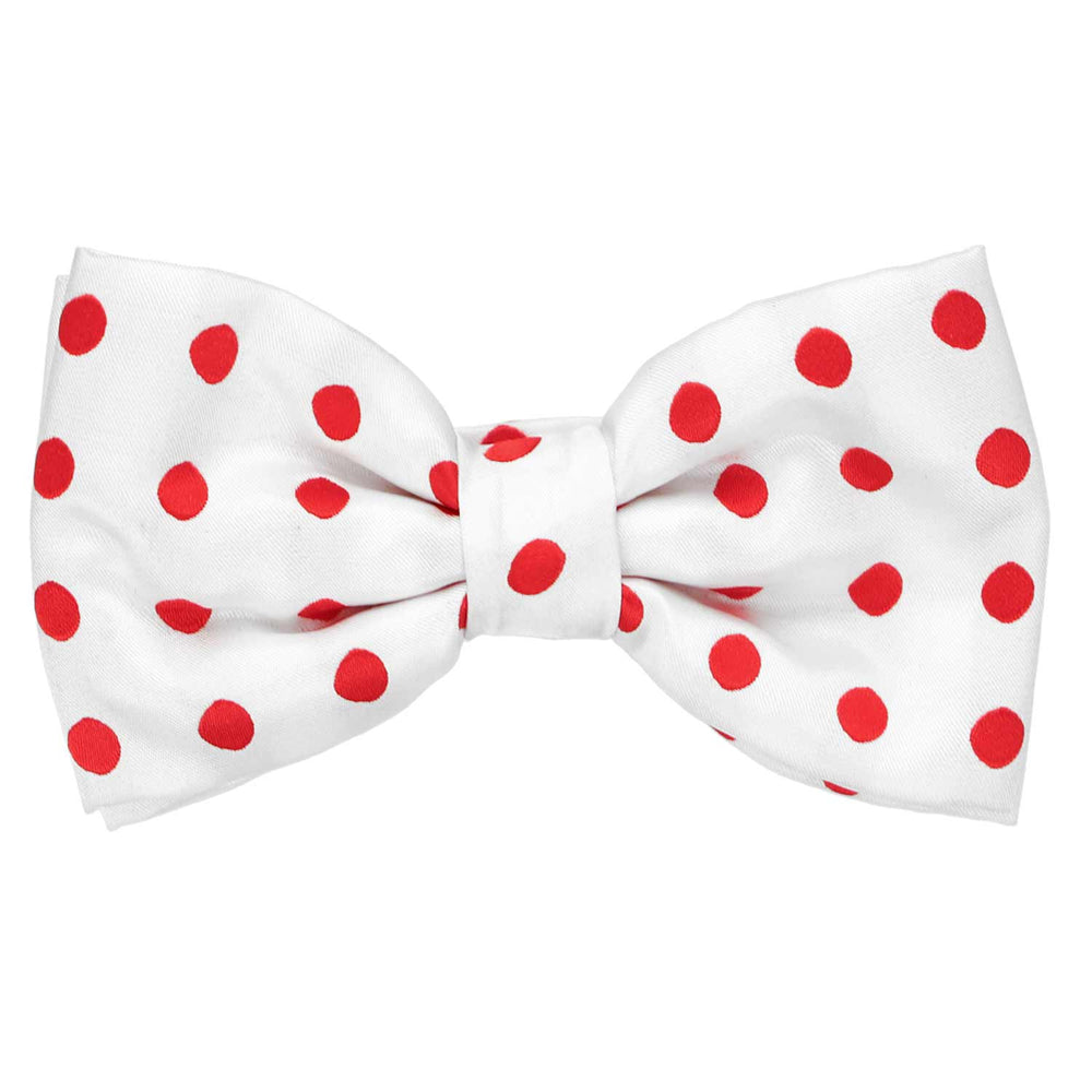 A white pre-tied bow tie with red medium-sized polka dots