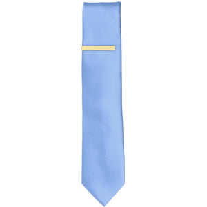 A solid butter yellow tie bar on a cornflower necktie