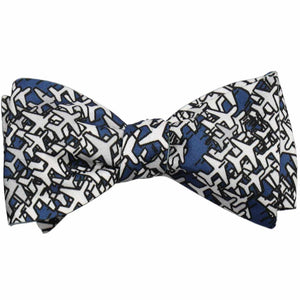 A tied dark blue bow tie with gray airplanes scattered across it