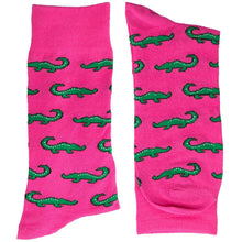 Load image into Gallery viewer, A folded pair of men&#39;s hot pink socks with green alligators
