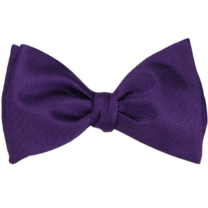 An amethyst purple self-tie bow tie, tied