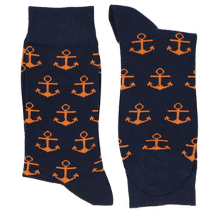 A pair of navy blue socks with orange anchors