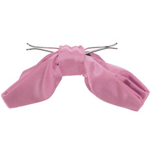 Load image into Gallery viewer, The side view of an antique pink clip-on bow tie, opened