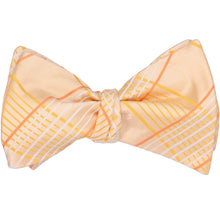 Load image into Gallery viewer, An apricot plaid self-tie bow tie, tied