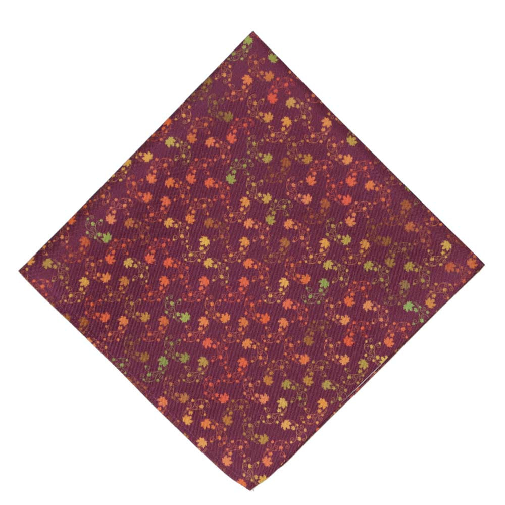 A burgundy pocket square, folded into a diamond, with a colorful leaf pattern