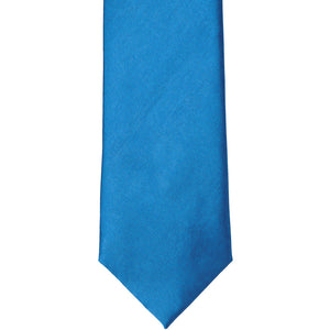 The front of an azure blue solid tie, laid out flat