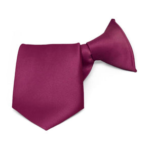 A boys raspberry clip-on bow tie, rolled to show off the color