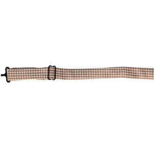The band collar on a floppy bow tie, in a brown circle pattern