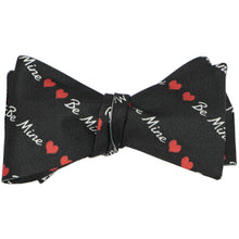 Load image into Gallery viewer, A black tied bow tie with a striped heart and be mine text pattern
