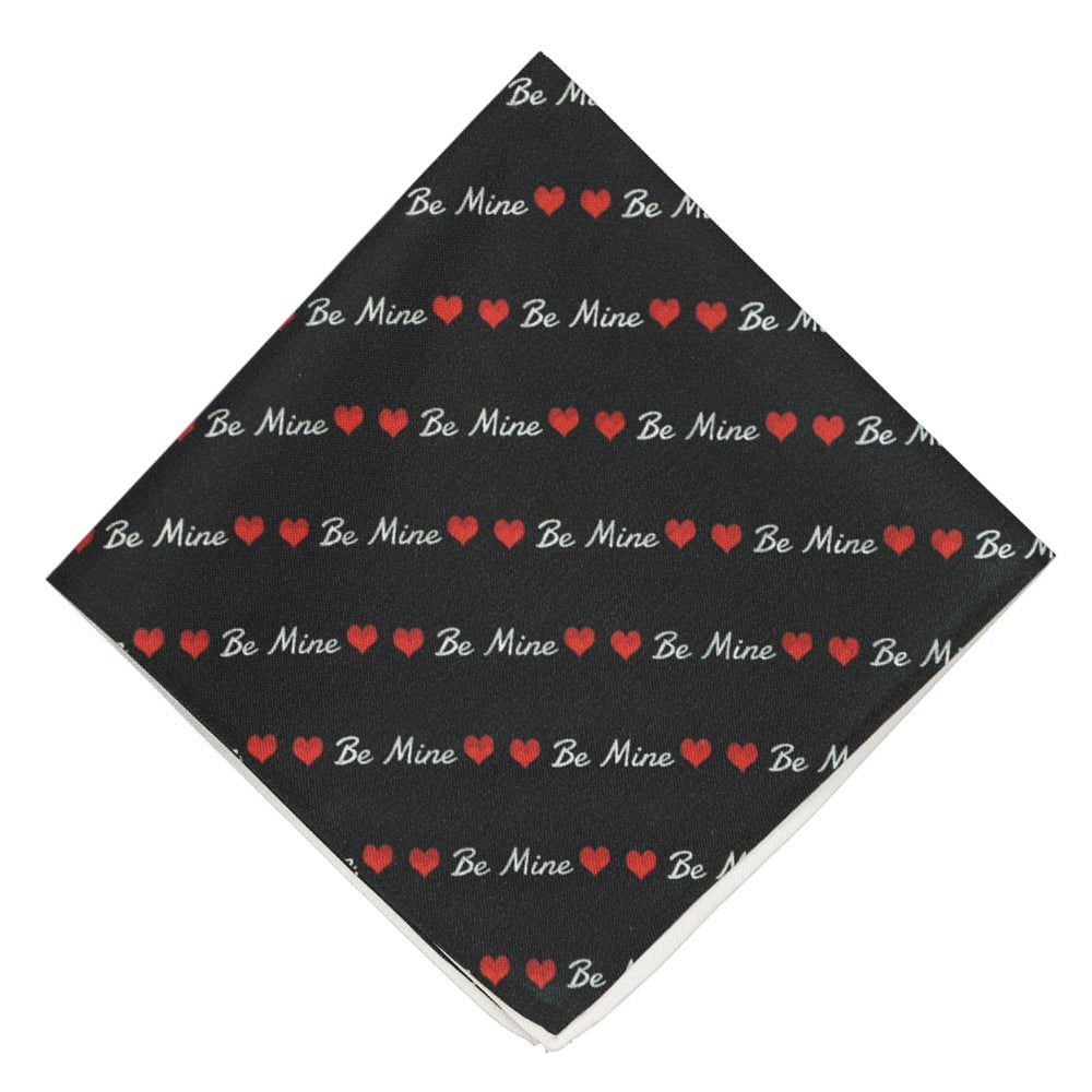 A folded black pocket square with Be Mine striped text and hearts