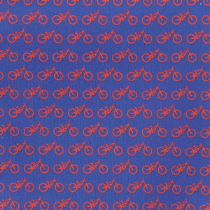 Zoomed in image of a blue pocket square with red bicycles printed on it.