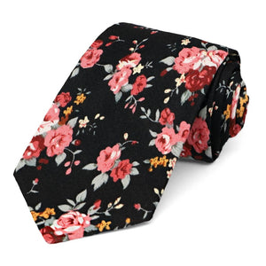 A coral and black narrow tie, rolled to show off the pattern