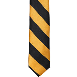 The front of a black and gold bar striped skinny tie, laid out flat