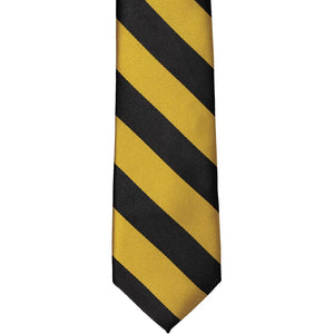 The front of a black and gold striped tie, laid out flat