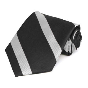 Black and silver striped necktie rolled to show the texture of the silver stripes