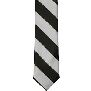 The front of a black and silver striped skinny tie, laid out flat