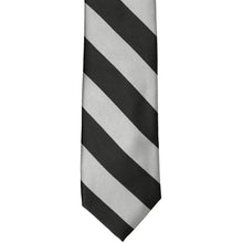 Load image into Gallery viewer, The front of a black and silver striped slim tie, laid out flat