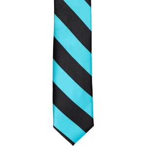 The front tip of a black and turquoise striped skinny tie, laid out flat