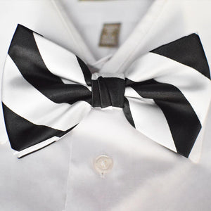 A black and white striped bow tie paired with a white dress shirt