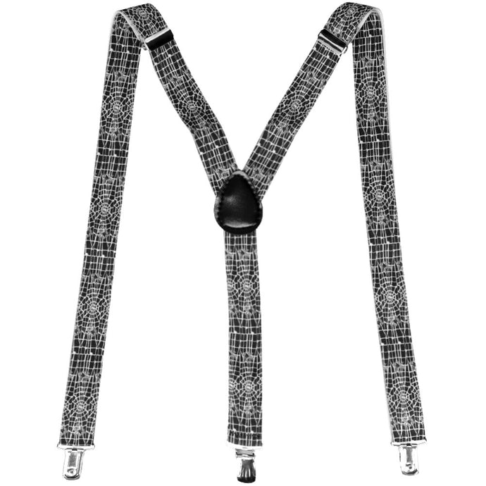 A pair of spider web suspenders in black and white, laid out into an M shape