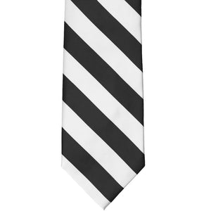 The front of a black and white striped tie, laid out flat