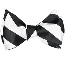 Load image into Gallery viewer, A black and white striped self-tie bow tie, tied