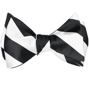 A black and white striped self-tie bow tie, tied