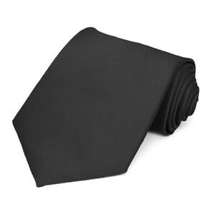 Solid black extra long tie, rolled to show woven texture