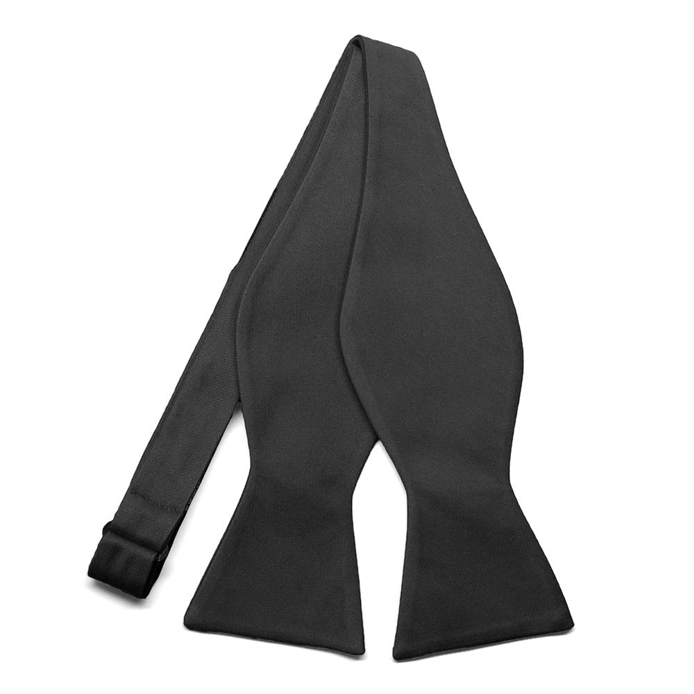 An untied solid black self-tie bow tie