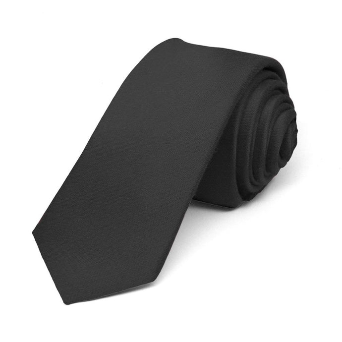 Solid black skinny tie, rolled to show woven texture