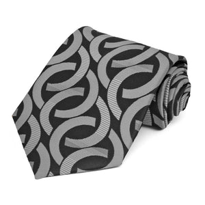 Rolled view of a black and silver link pattern necktie