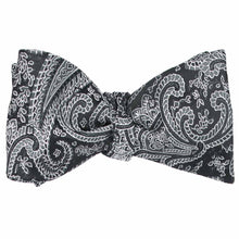 Load image into Gallery viewer, A tied self-tie bow tie in a black and gray paisley pattern